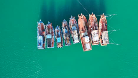 lovely aerial top view flight boats anchoring in sea, island ko kut ao phrao beach, thailand 2022