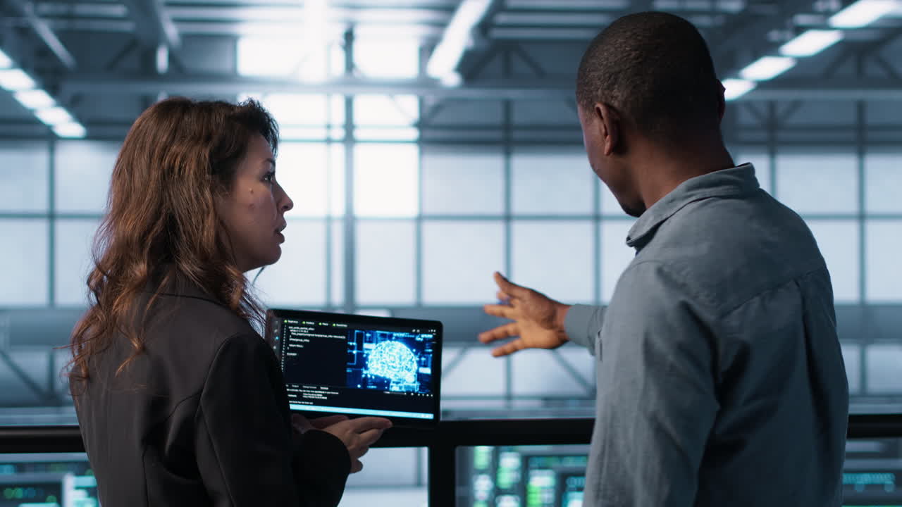 Software developers in data center use AI technology on tablet