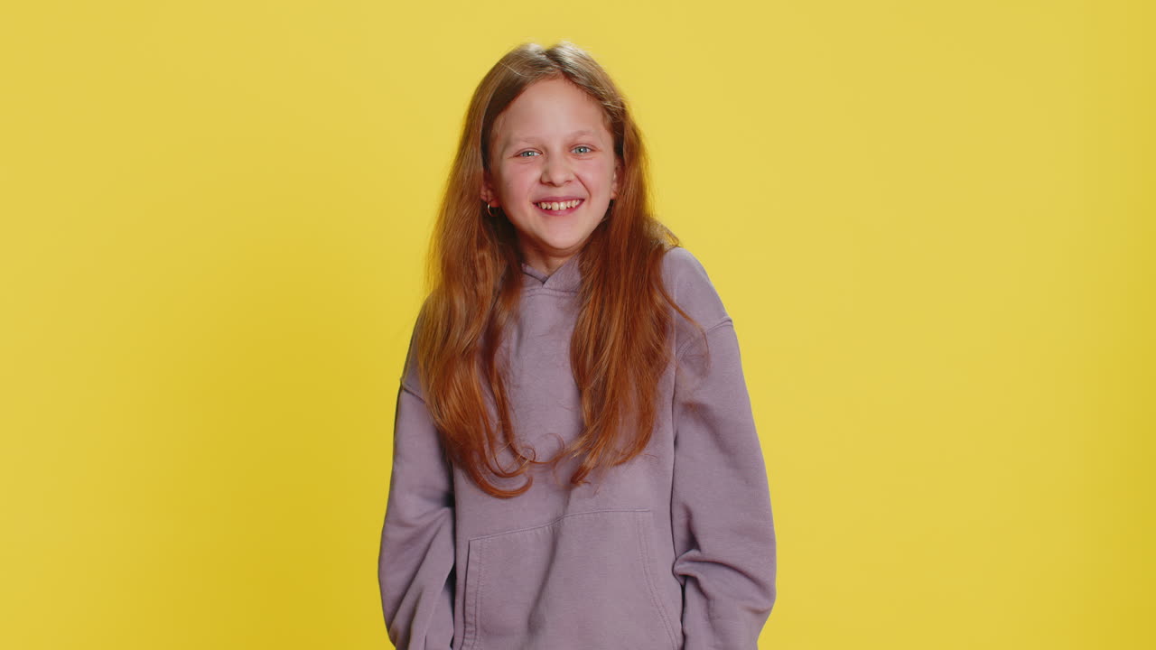 Happy excited child girl laughing out loud after hearing ridiculous anecdote reaction on funny joke