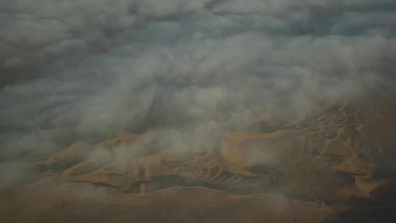 Flying high above the Namib Desert, with early morning fog over the dunes