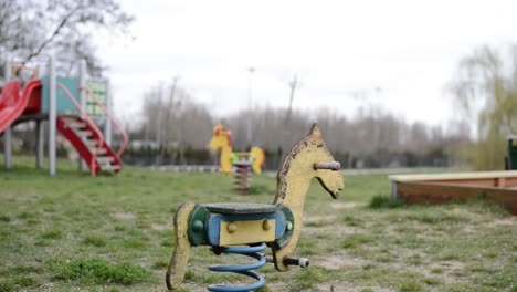 horse-spring-swing-alone-in-an-outdoor-park-close-for-the-lockdown-of-the-city-for-pandemic-virus-emergency-alert