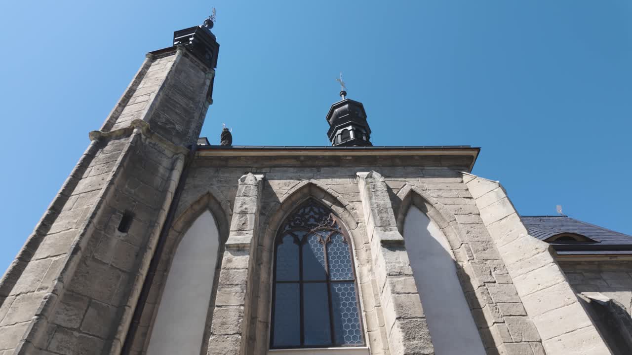View of the Sedlec Ossuary's exterior in Kutna Hora, showcasing the historic architecture of the famous Church of Bones on a clear day. Tilt Up Shot