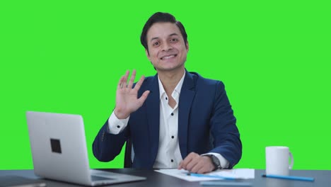 Happy-Indian-businessman-waving-Hi-to-the-camera-Green-screen