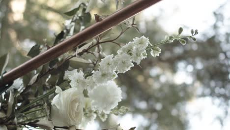 a bouquet of flowers tied to a metal arbor