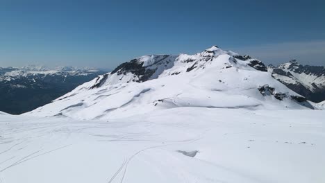 spectacular panoramic aerial drone view of grand massif area within sight of mont blanc, france. drone going forward. famous travel destination for winter sports. snowy winter in french alps.