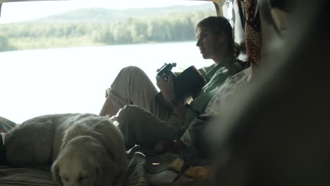 woman playing the guitar in camper van