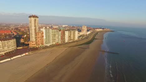 Aerial:-The-boulevard,-beach-and-city-of-Vlissingen-during-sunset