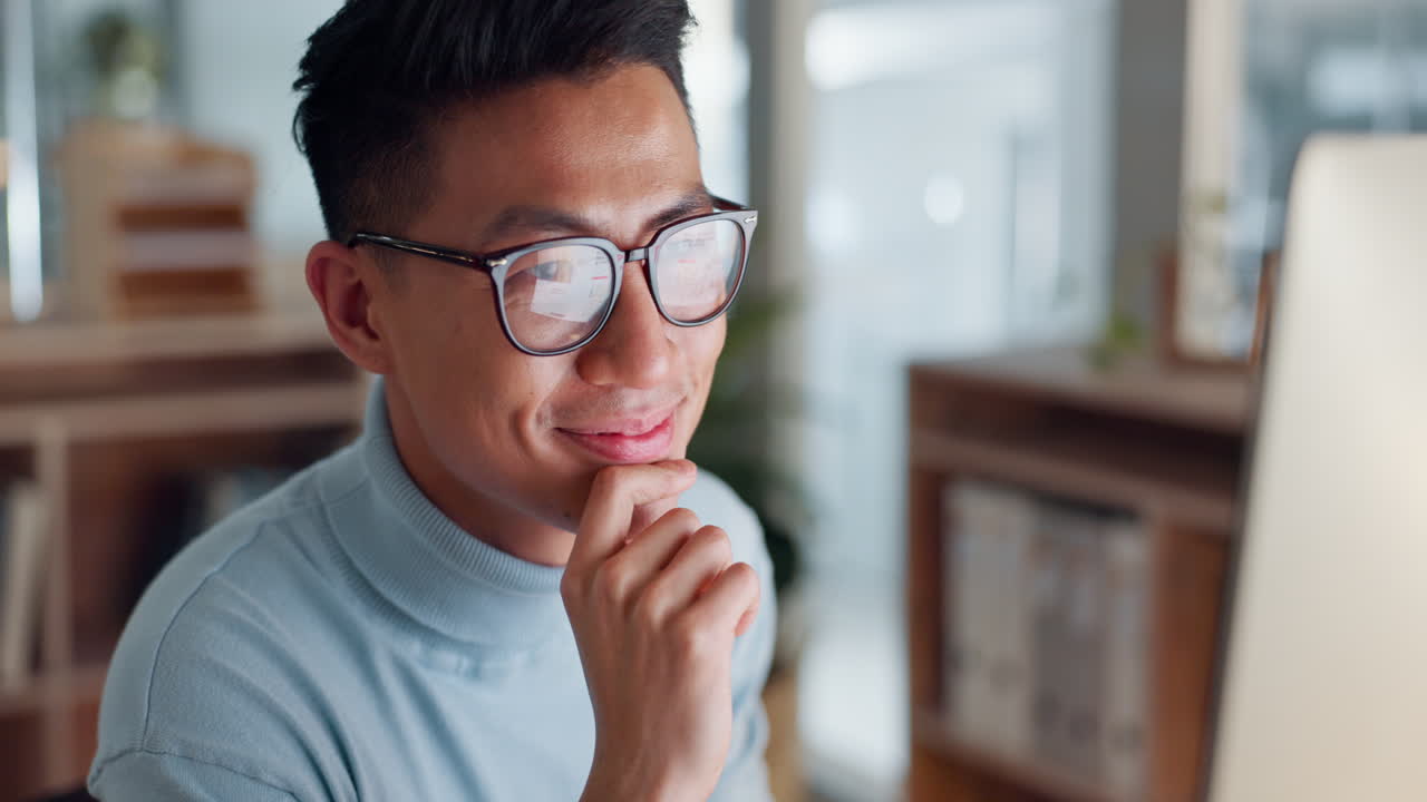 Asian man at computer, glasses and ideas