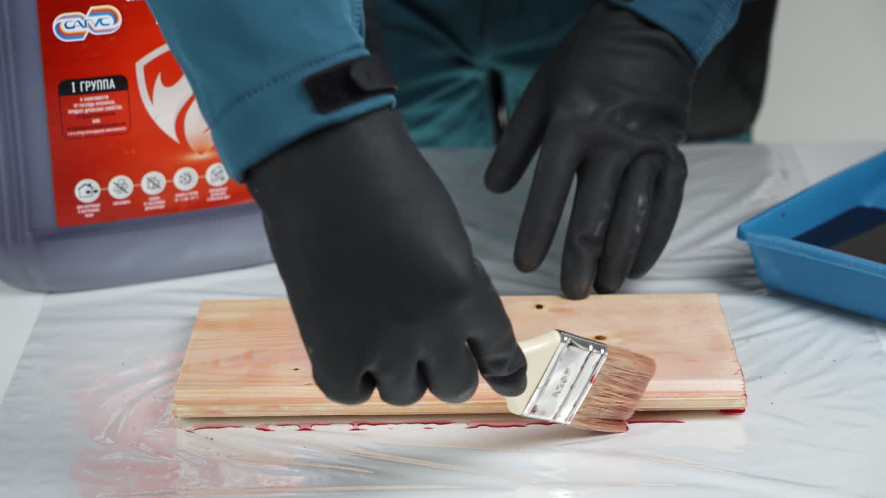 Applying Wood Stain with Protective Gloves