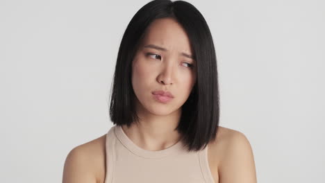 Asian-woman-looking-sad-on-camera.