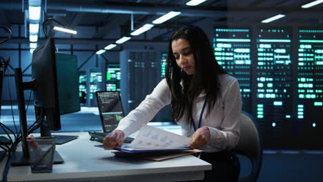 engineer in data center installing software on computer