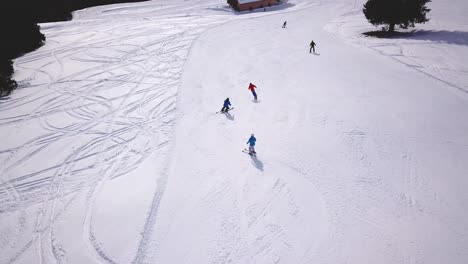 People-skiing-and-snowboarding-on-snow-slope-in-winter-ski-resort