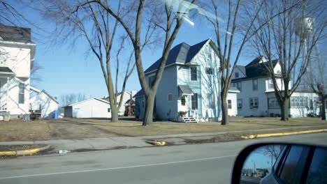 driving through a neighborhood on a sunny winter day