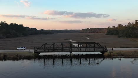 bridge over the river, car passing through small town