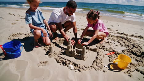 family fun on the beach building a sandcastle