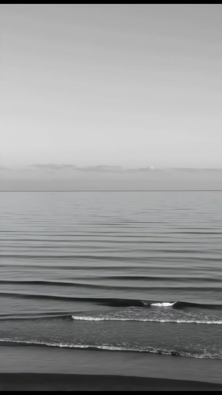 Calm Monochrome Ocean With Ripples, Gentle Waves Rolling To Shore, Distant Horizon, Meditative Grayscale Mood,