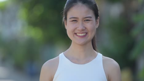 young happy beautiful asian businesswoman smiling outdoors