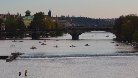 small tourist boats canoe swim in the vltava river in prague czech republic