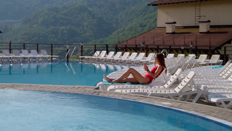 woman relaxing by the pool with mountains view