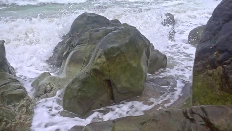 Huge-Boulder-of-Rocks-at-Banbanon-Beach-with-Ocean-Waves-Splashing-in-Slow-Motion-at-Surigao-Del-Norte,-Philippines