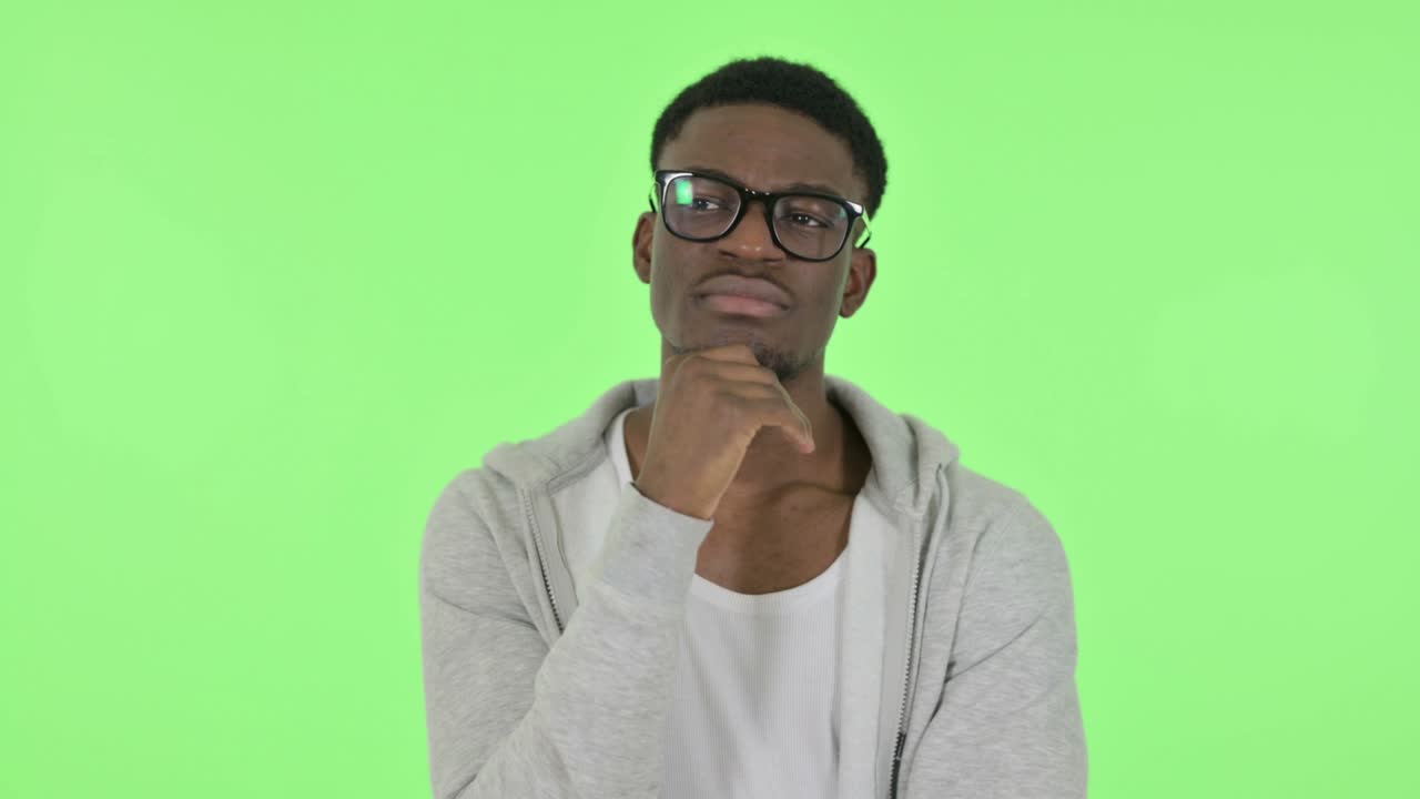 Pensive African Man Thinking and getting Idea on Green Background