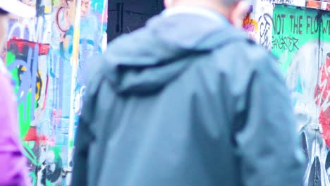 people observing vibrant graffiti in melbourne alley