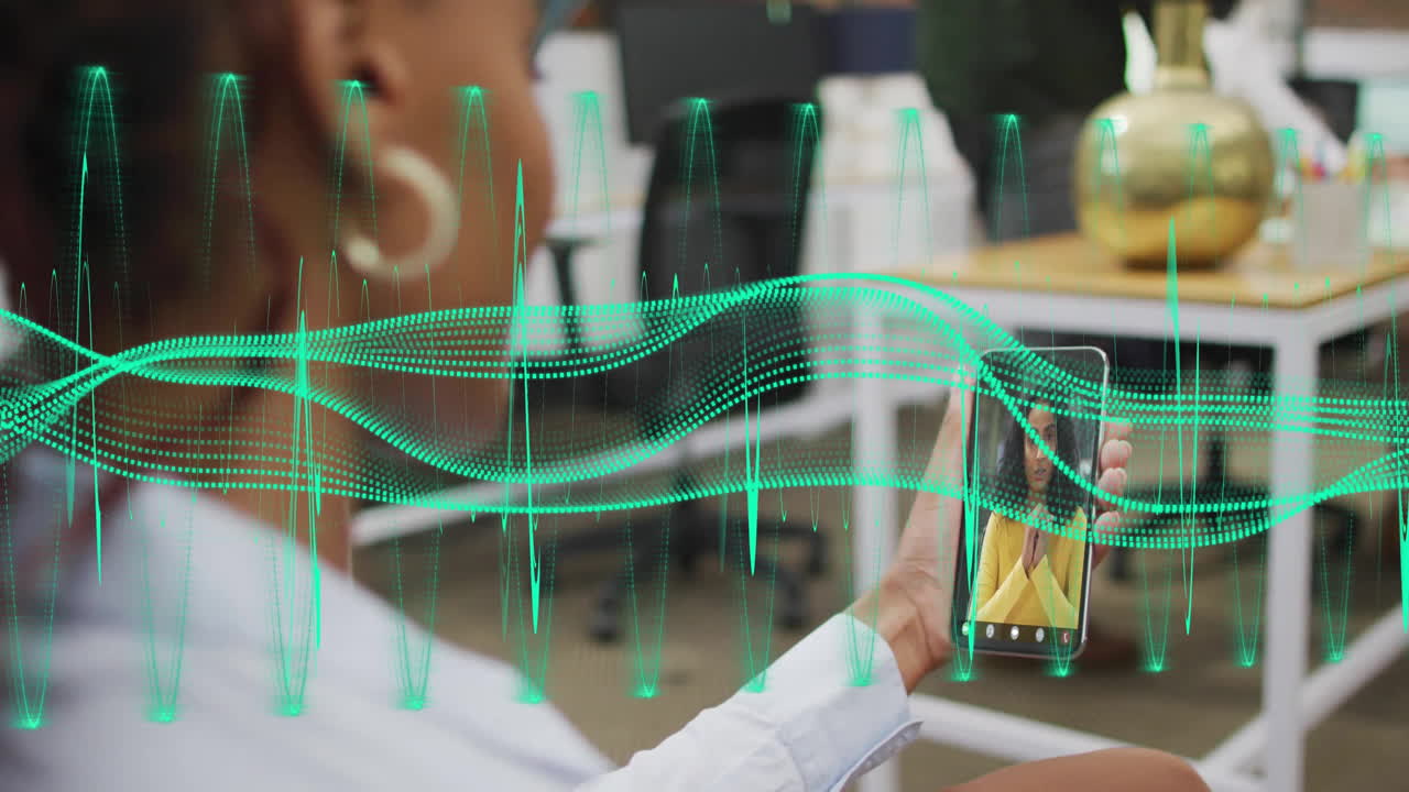 Person holding smartphone with digital wave animation over office background