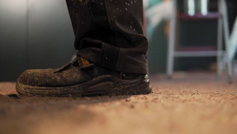 closeup shot in 4k of man's feet that paints with spray paint