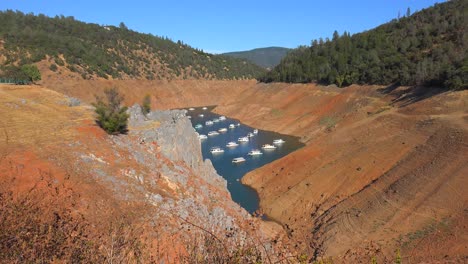 wide shot of houseboats sitting in low water at oroville lake in california during extreme drought