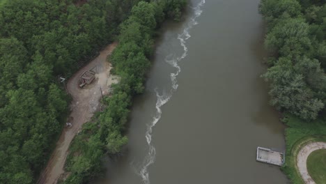 drone flies over a river in the midwestern usa and pans up to eventually reveal a quarry