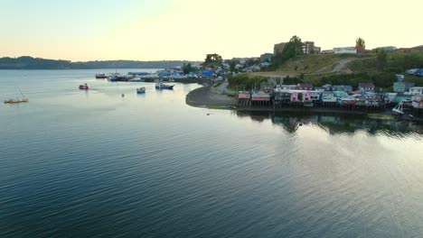 Aerial-Sunset-Landscape-Skyline-at-Waveless-Sea-of-Palafitos-Pedro-Montt-Chiloé-Chilean-Patagonia-Travel-Destination