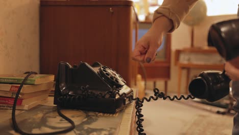 woman using an old rotary dial telephone