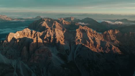 Aerial-view-of-the-famous-Dolomite-peaks-in-Cortina-D'Ampezzo-national-park-at-sunrise,-with-Punta-su-di-fanes,-Punta-nord-and-Monte-Ciaval-visible-from-Tofana-di-Rozes