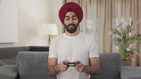 happy sikh indian man playing video games