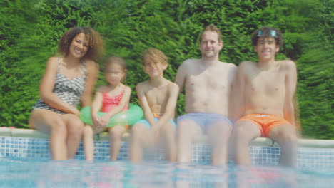 Retrato-De-Una-Familia-Multirracial-Relajándose-En-La-Piscina-Durante-Las-Vacaciones-De-Verano-Tomada-Desde-El-Agua