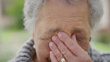 close up portrait of retired senior woman feeling tired sleepy looking at camera close up