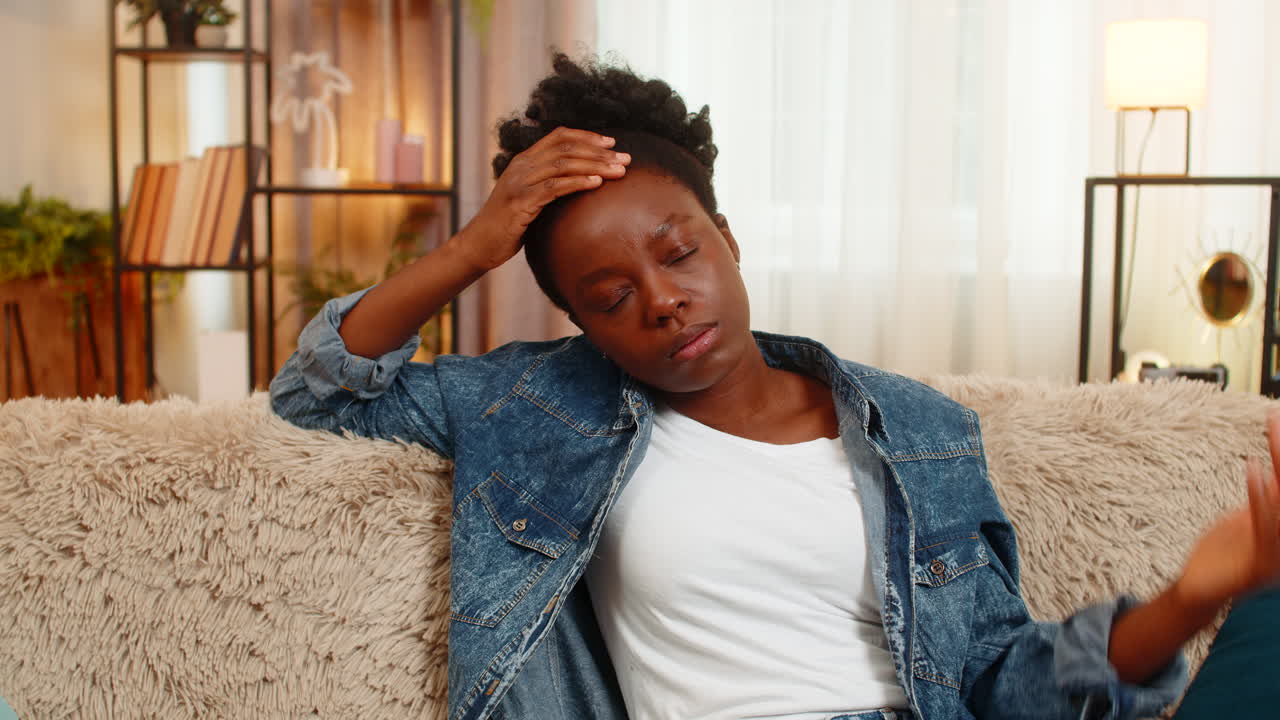 African american woman stressed on sofa thinking after bad day financial failure or personal issues