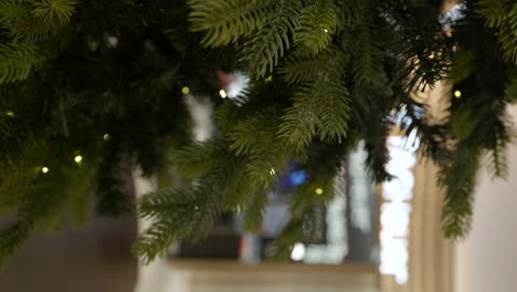 Vertical-Shot-Of-An-Artificial-Christmas-Tree-With-Fairy-Lights-Inside-A-Shopping-Mall