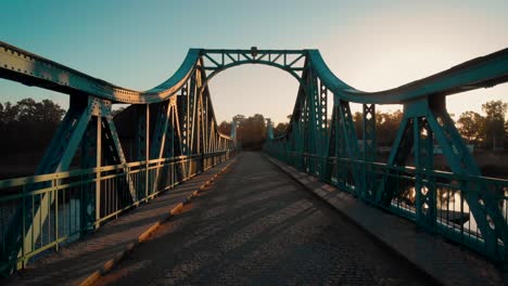 caminando sobre un puente verde de metal al amanecer en polonia