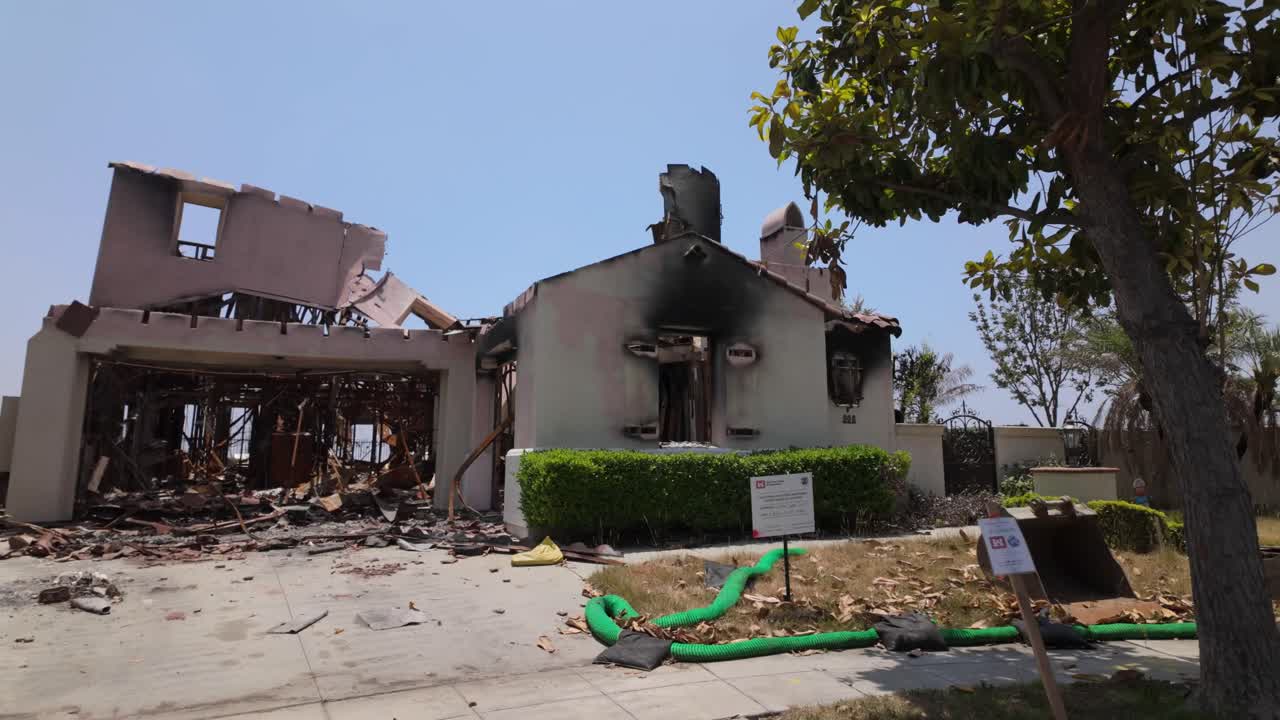 Gimbal wide panning shot of a home burned by the Eaton Fire in Altadena, California. 4K