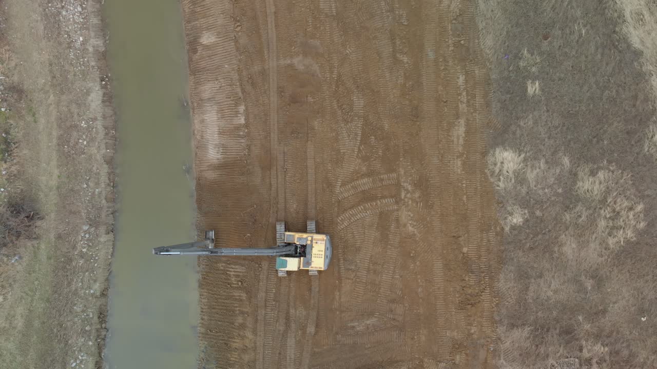 Aerial Timelapse of Two Excavator working strengthening of the River Outlet from the Banks during flooding