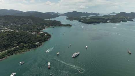 Luxurious-Yacht-and-Fishing-Boats-in-South-China-Sea,-4K-Aerial-view