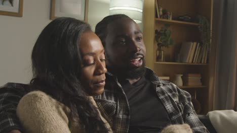 Loving-Young-Couple-Relaxing-At-Home-Sitting-On-Sofa-Talking-Together-2