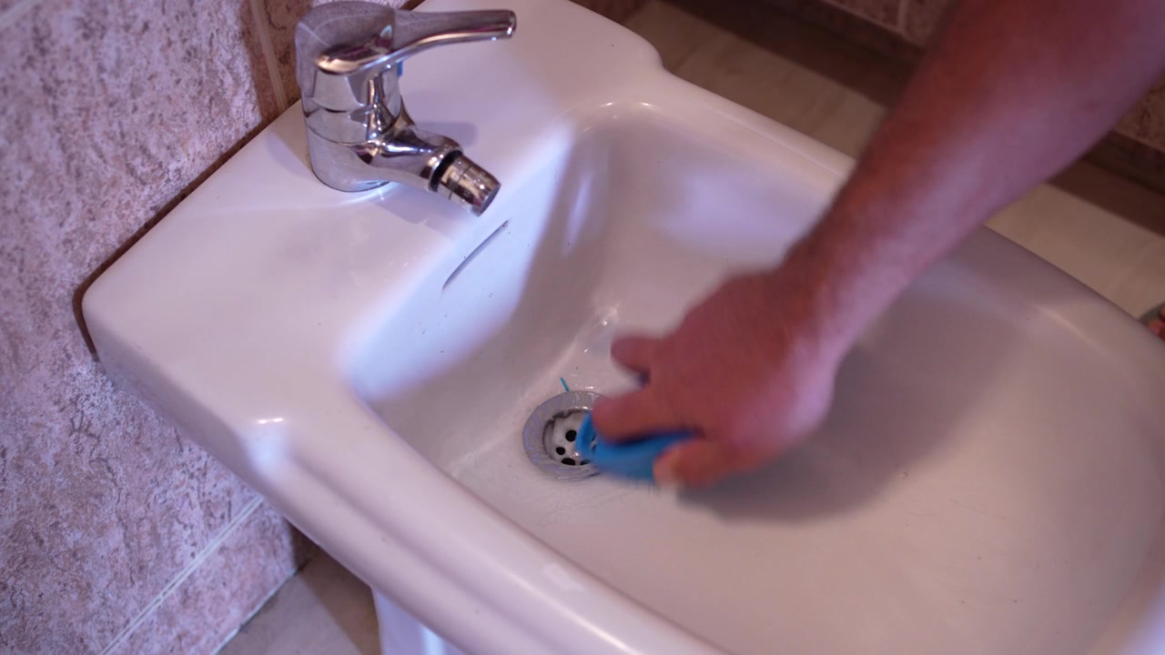 Thoroughly cleaning bidet in the bathroom using a sponge for maintenance and hygiene
