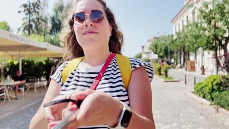 young woman vlogger filming with selfie stick in athens
