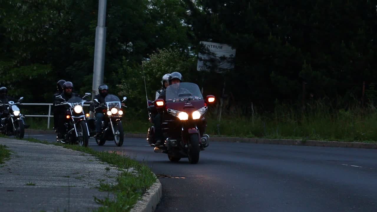 Cinematic slow motion rolling shot of motorbike club touring on road, Slovakia