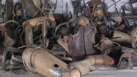 old stolen wooden prosthetic legs in a concentration camp auschwitz birkenau poland