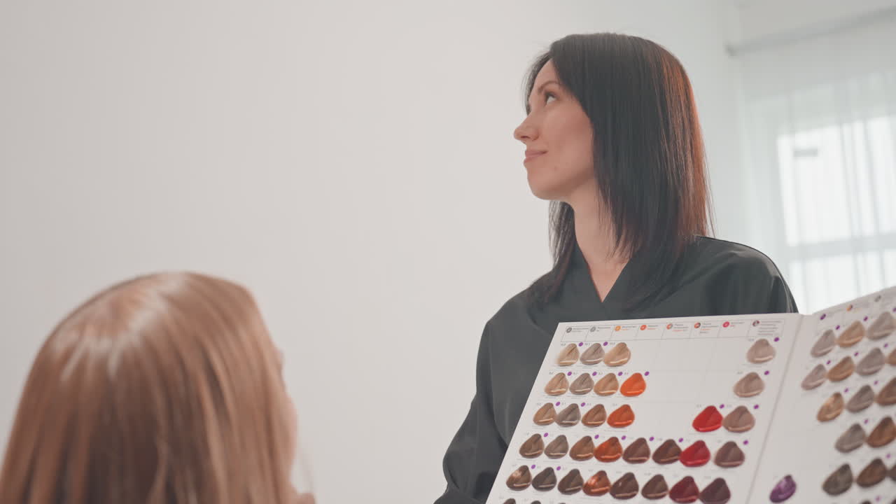 Hair color matching session with colorist engaging client in shade testing, playful collaboration with palette swatches, suggestions for balayage and maintenance, warm window light and friendly