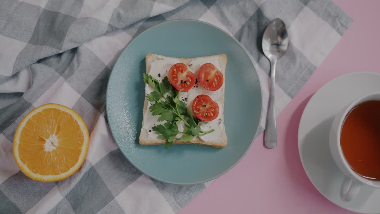 Simple Breakfast with Toast, Cream Cheese, Tomatoes, Parsley and Tea