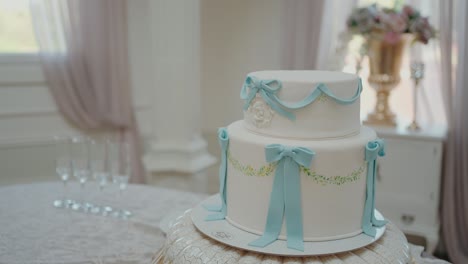 stunning two tier cake adorned with elegant blue ribbons